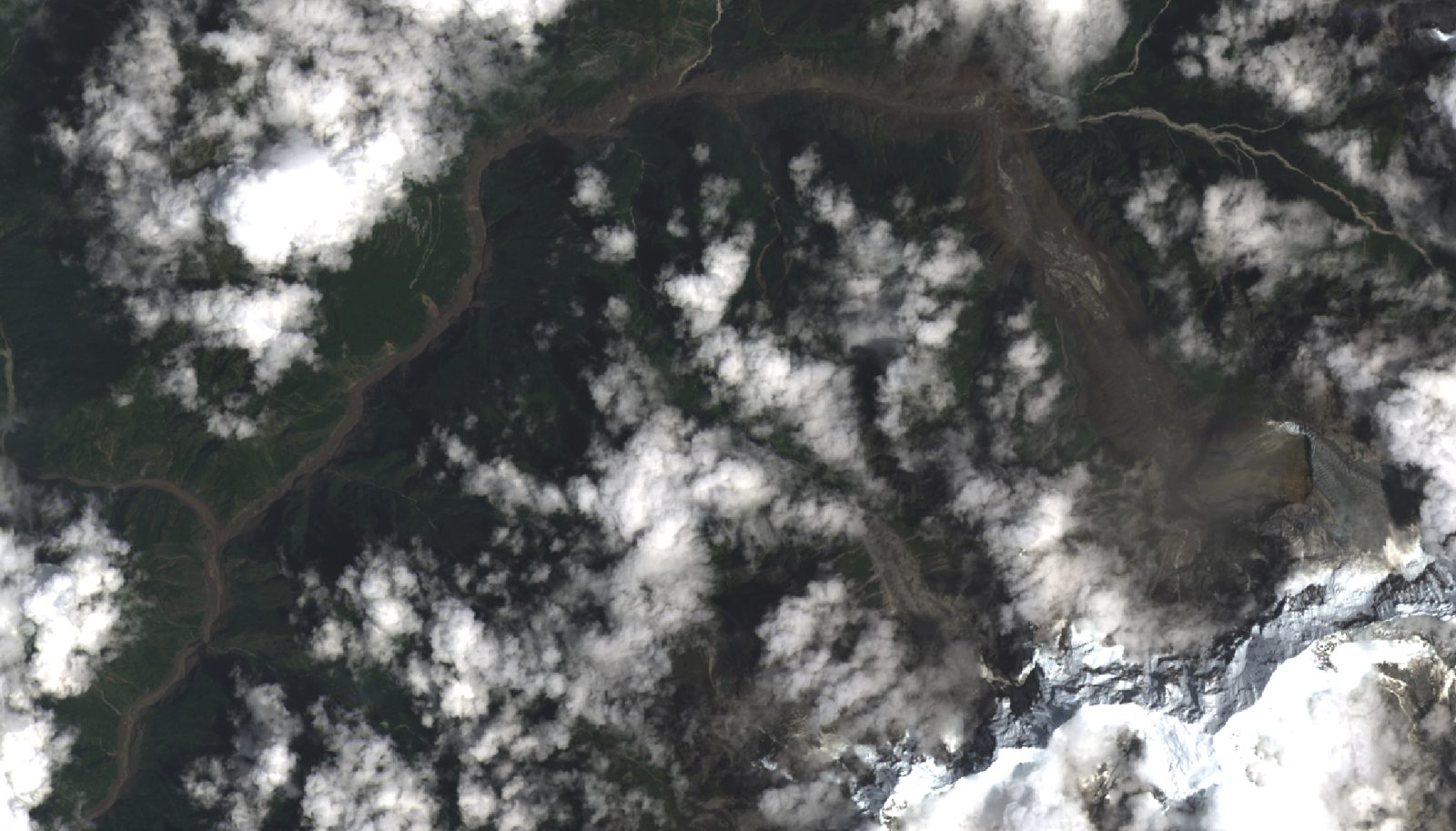 Satellite view of a brown debris path cutting through forested Himalayan valleys after the August 26, 2026 floods